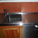 Stainless benchtop and sink in a timber kitchen